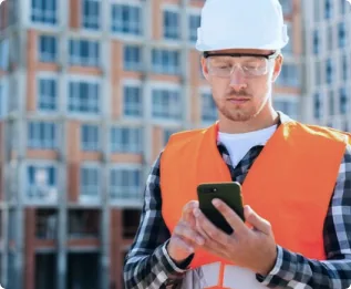 A foreman logging a snag from a phone on site